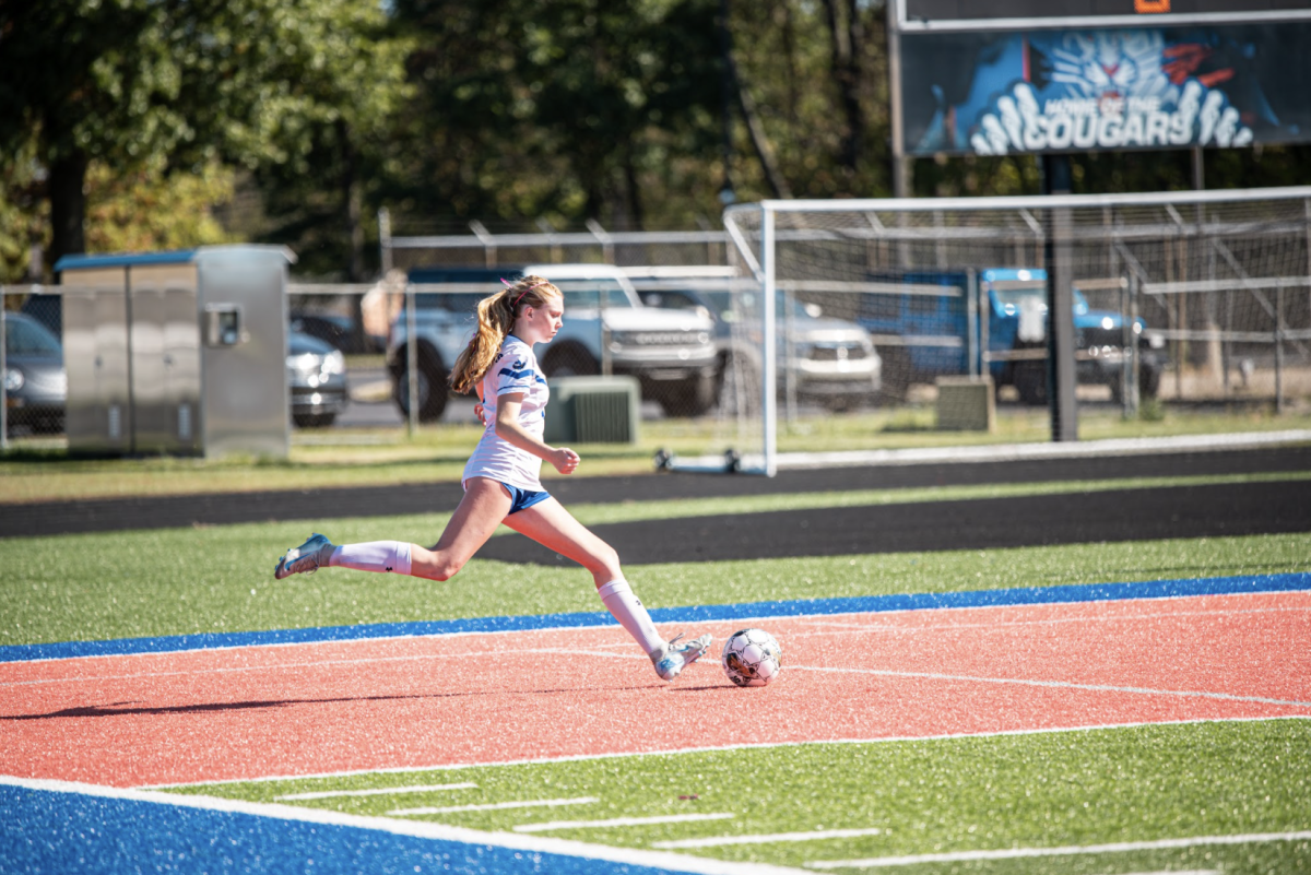 Kaylee Mills (11) services the ball. 